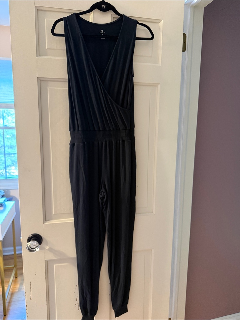 Peach Women's Black Sleeveless Jumpsuit. Elasticized waist and pockets